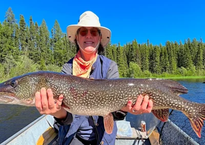 Fisherman holding a trophy Northern Pike in Manitoba.