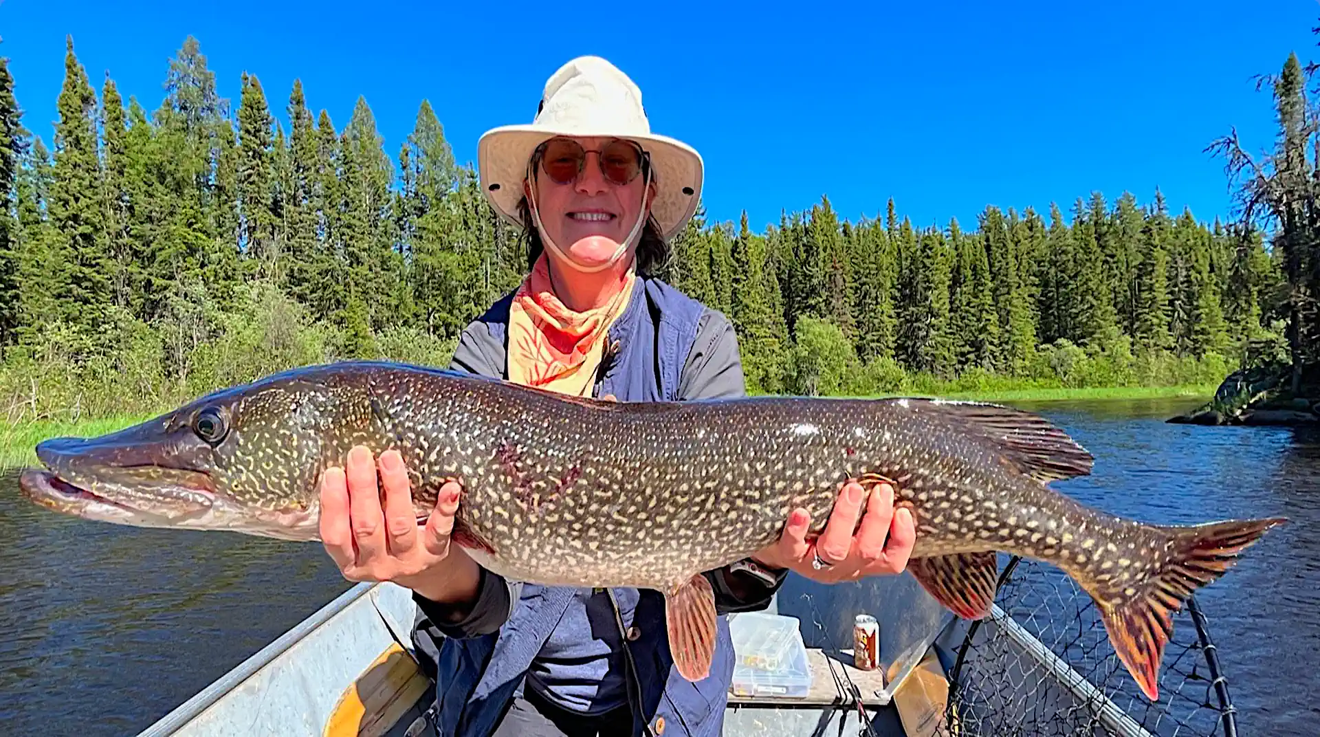 Fisherman holding a trophy Northern Pike in Manitoba.