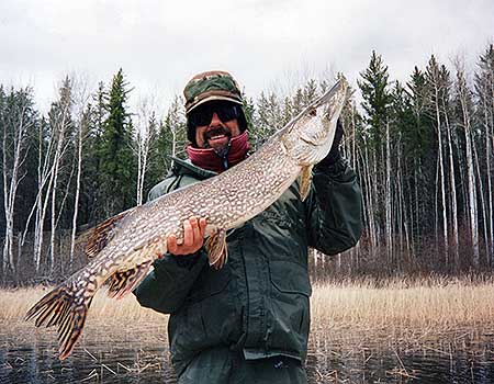 Mark's 46-inch fish kicked off an unbelievable day of pike fishing. Trophy Canada Pike Fishing.